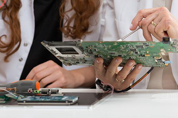 Hands working with a circuit board